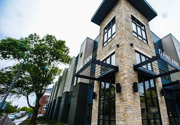 A modern building with a stone facade and large windows.