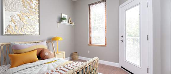 a bedroom with a bed and two windows