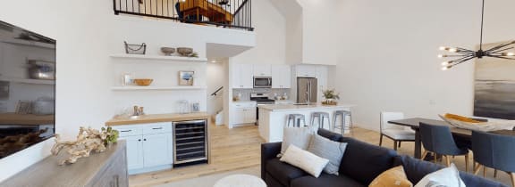 a living room with a couch and a kitchen in the background at Novella Biltmore, Phoenix, AZ 85016