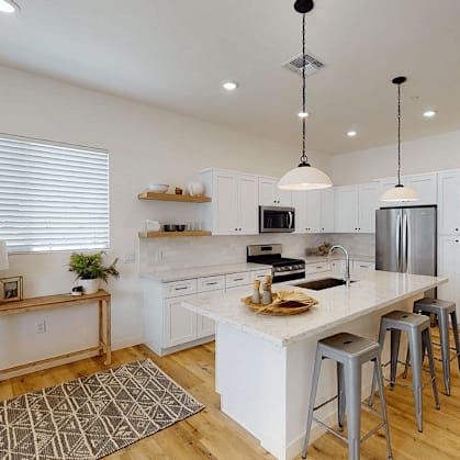 a kitchen with a large island with bar stools at Novella Biltmore, Phoenix, 85016