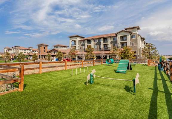 a park with a playground and buildings in the background at Terracina, Colorado 80020