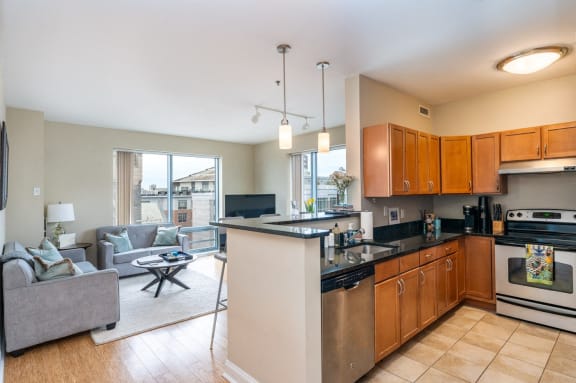 a kitchen with an island and a living room with a couch