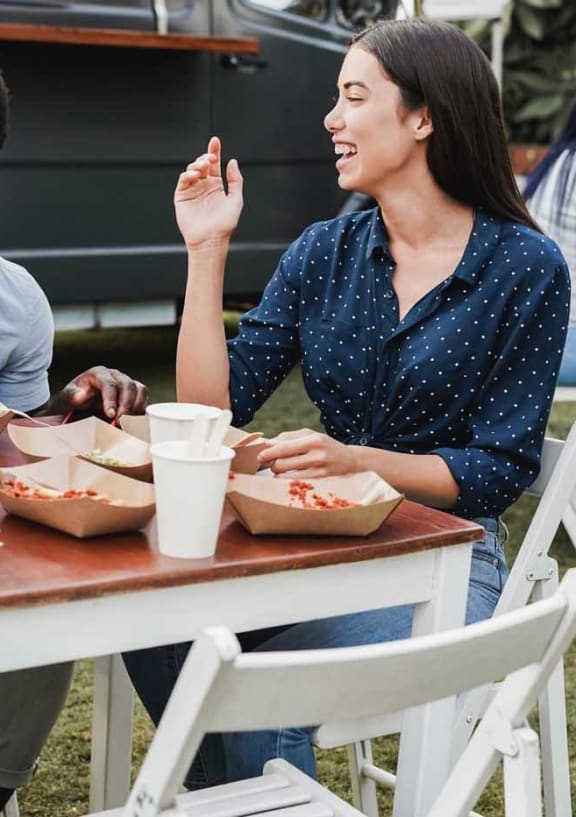a group of people sitting around a table eating food