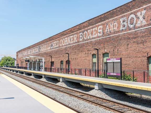 A train station with the words "Boxcar Box and Box" on the side of the building.