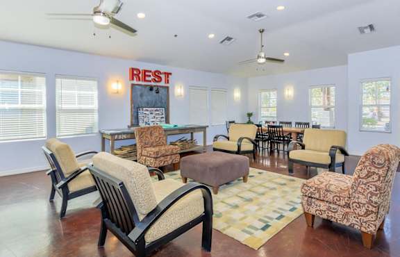 A living room with a sign that says "RIEST" on the wall.