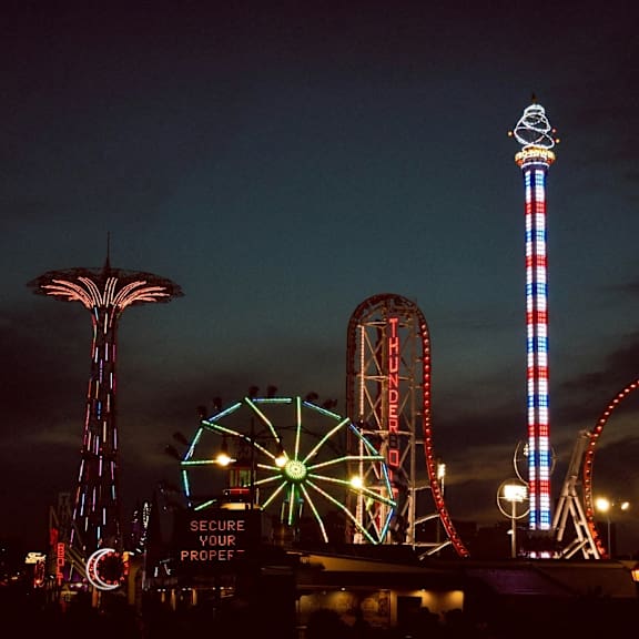 An amusement park lit up at night.