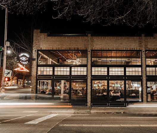 a night view of the front of the building at The Hemlock, Seattle, WA