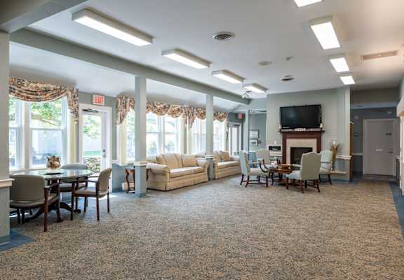 A spacious living room with a fireplace and a television.