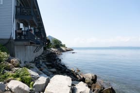 a house on the edge of a cliff overlooking a body of water