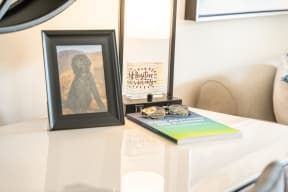 a table with a book and a lamp on it