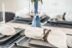 a table set with white napkins and silverware
