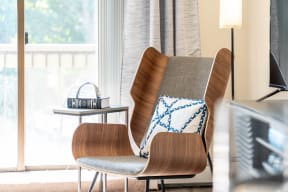 a chair with a pillow on it in a living room