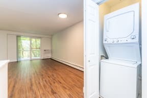 an empty laundry room with a washer and dryer in it
