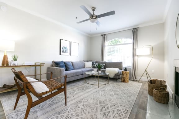 a living room with a couch chair and coffee table