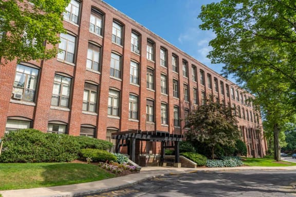 a large brick building with a sidewalk in front of it