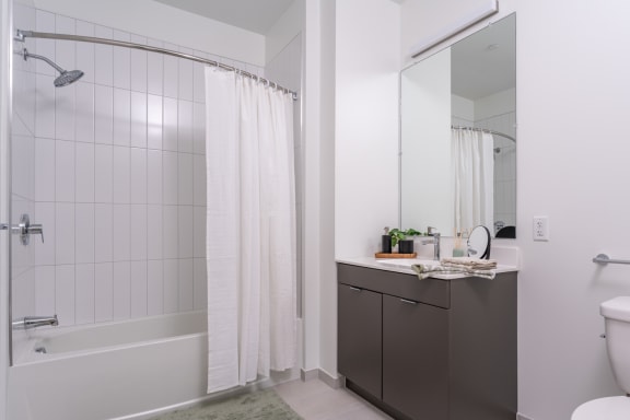 a bathroom with a shower and a sink and a toilet