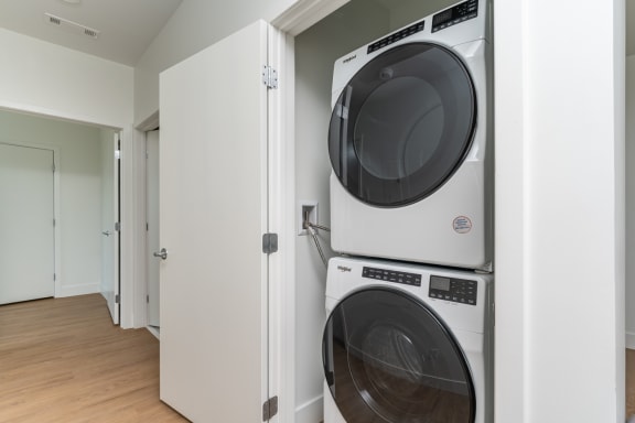 a front loading washer and dryer in a laundry room