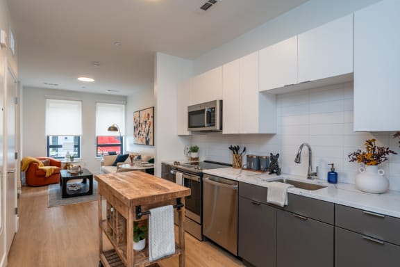 a kitchen with stainless steel appliances and a wooden table