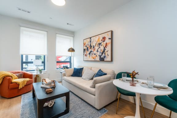 a living room with a couch and a table and a window