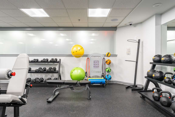 a fitness room with weights and other exercise equipment
