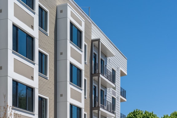 a row of apartment buildings with balconies against a blue sky at Union 346, Somerville, MA