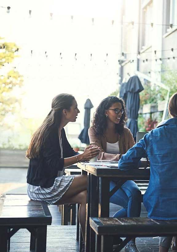 a group of people sitting on wooden benches