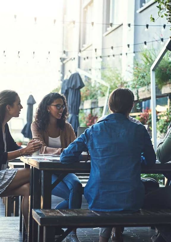 a group of people sitting on wooden benches