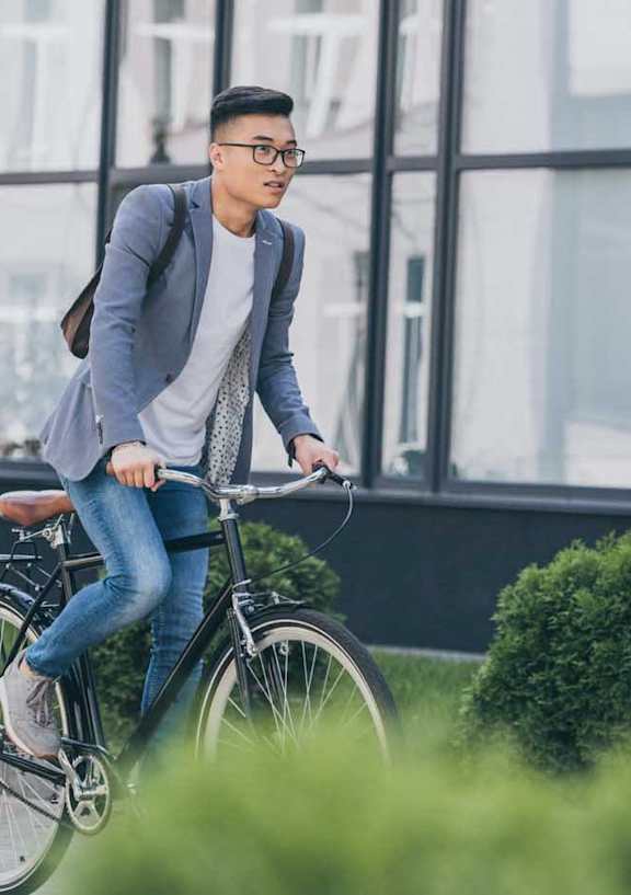 a man riding a bike down a street