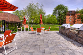 BBQ grills and a patio with dining tables