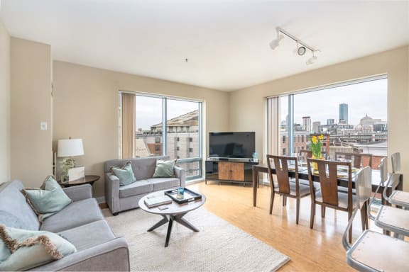 a living room with a couch and a table and a large window