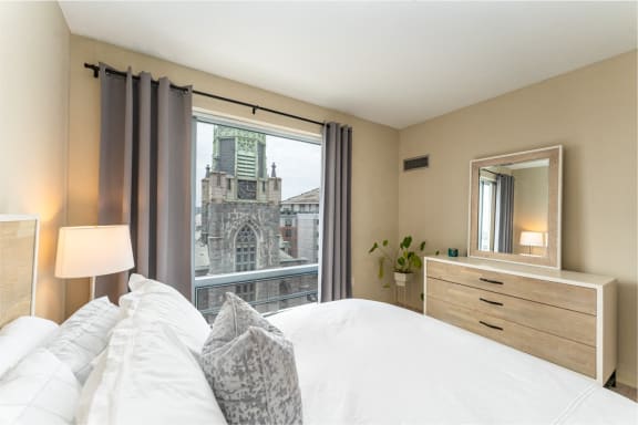 a bedroom with a bed and a view of a church