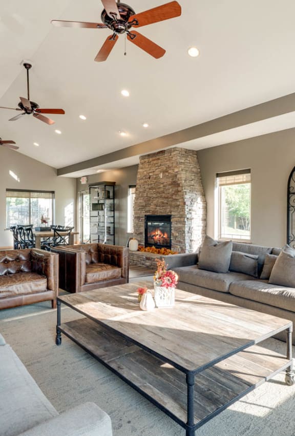 a living room with couches and a table and a fireplace