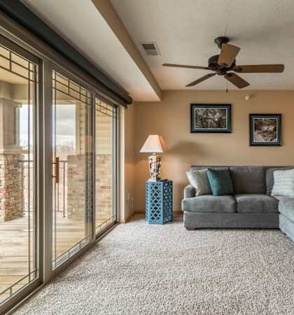a living room with a couch and a ceiling fan