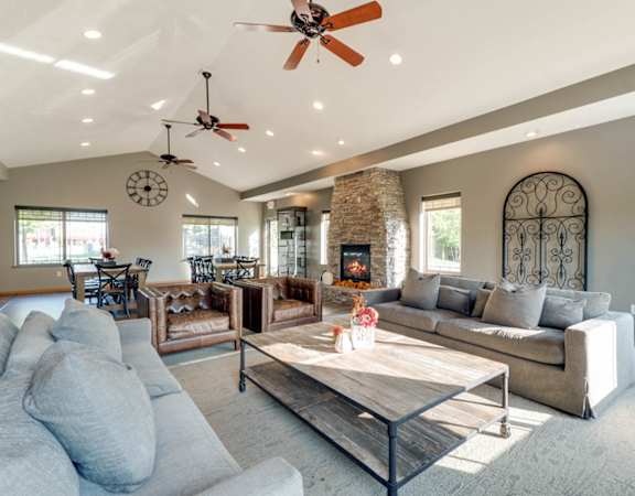 a living room with couches and a table and a fireplace