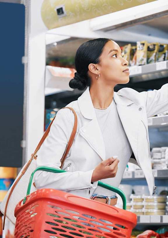 a woman shopping for food in a grocery store
