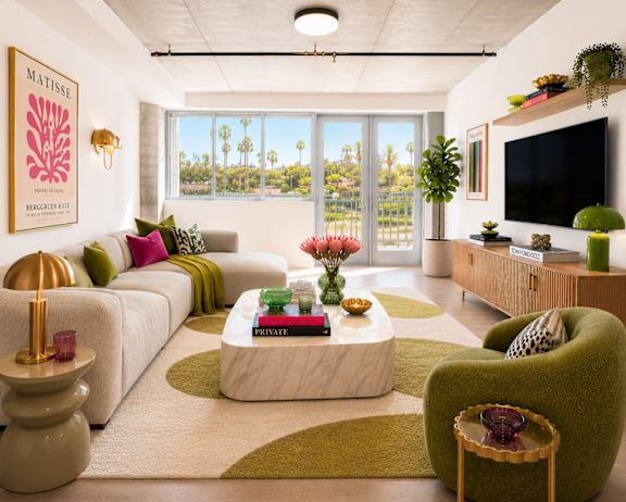 A living room with a white couch, a green armchair, and a coffee table with a book on it.
