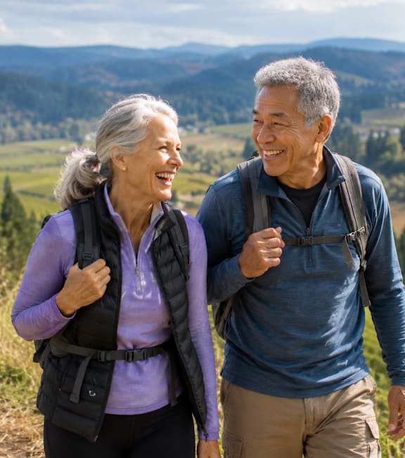 An older couple is hiking in a beautiful landscape.