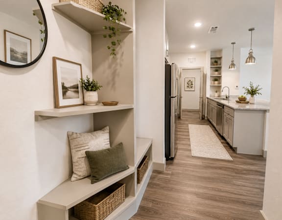 Apartment entryway with built-in storage, modern finishes, and luxury vinyl plank flooring.