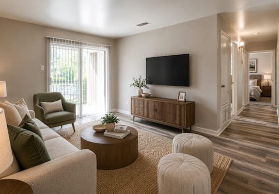 A living room with a large flat screen TV mounted on the wall.