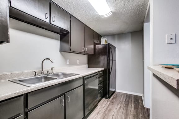 Updated Kitchen With Black Appliances at Falls on Clearwood Apartments, Richardson, TX, Texas