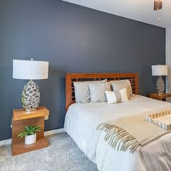 a bedroom with a bed and two night stands with lamps
