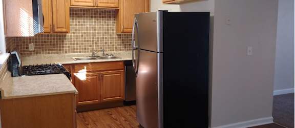 a kitchen with a refrigerator and a sink