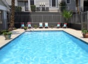 Thumbnail 11 of 13 - Pool with lounge chairs at Douglas Landing Apartment Homes, Austin