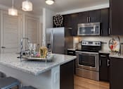 Thumbnail 34 of 35 - All kitchens feature stainless steel appliances and some include a breakfast bar.
