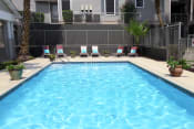 Thumbnail 11 of 13 - Pool with lounge chairs at Douglas Landing Apartment Homes, Austin