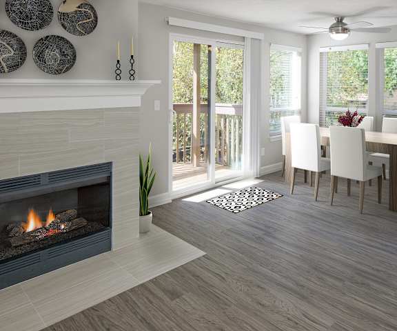 A modern living room with a fireplace and sliding glass doors.