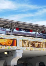 a train station with a mural on the side of it