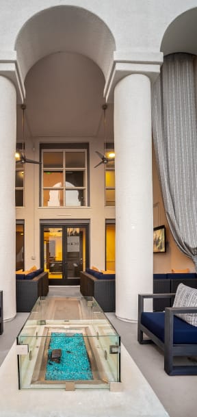 Outdoor lounge seating with a firepit at The Preston Miracle Mile Apartments, Los Angeles