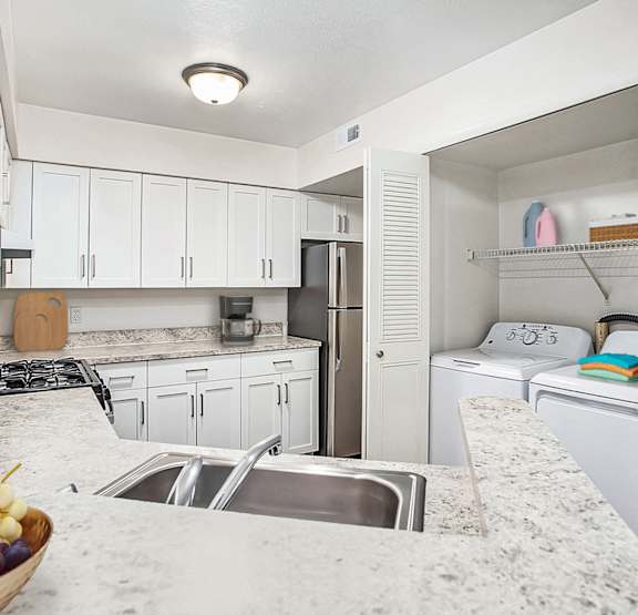 A kitchen with a washer and dryer at Brentwood Park Apartments in La Vista, NE 68128