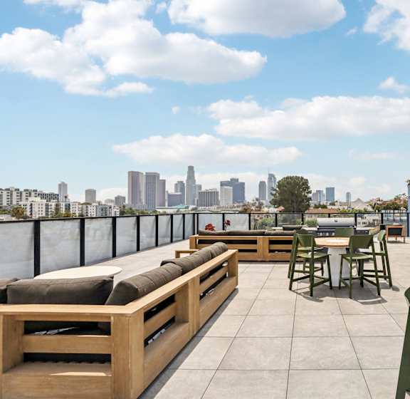 A blue building with a patio furniture set in front of it.